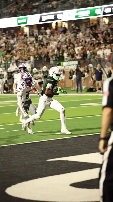 A football player carrying the ball toward the end zone in the Westlake highlight film